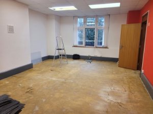 Carpet tiles lifted ready to paint the clinic room 